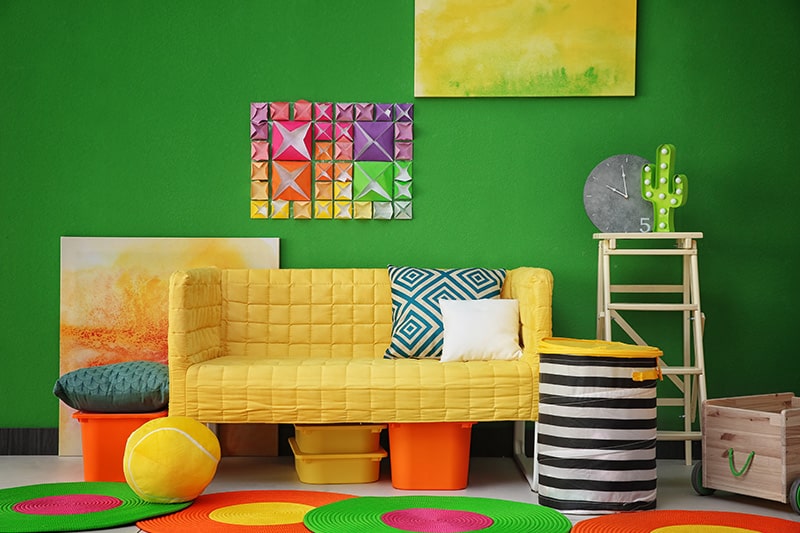 Fluorescent shade green living room colour paired with slightly eccentric and vivid furniture