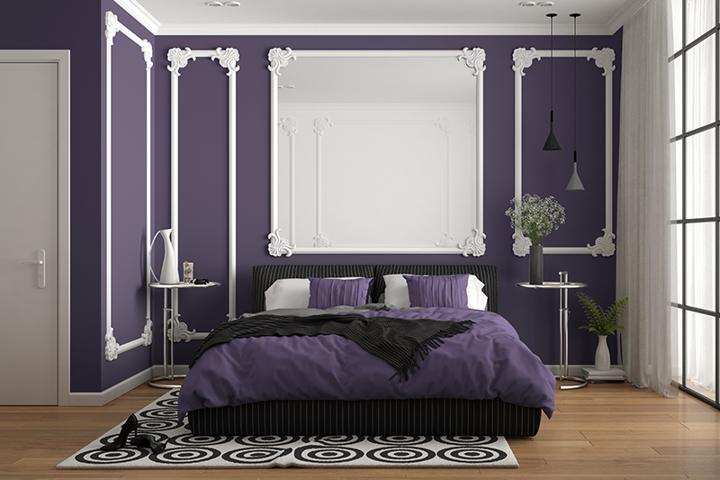 Purple bedroom colours with white wall mouldings and bedding pairs which gives the purple bedroom a touch of elegance