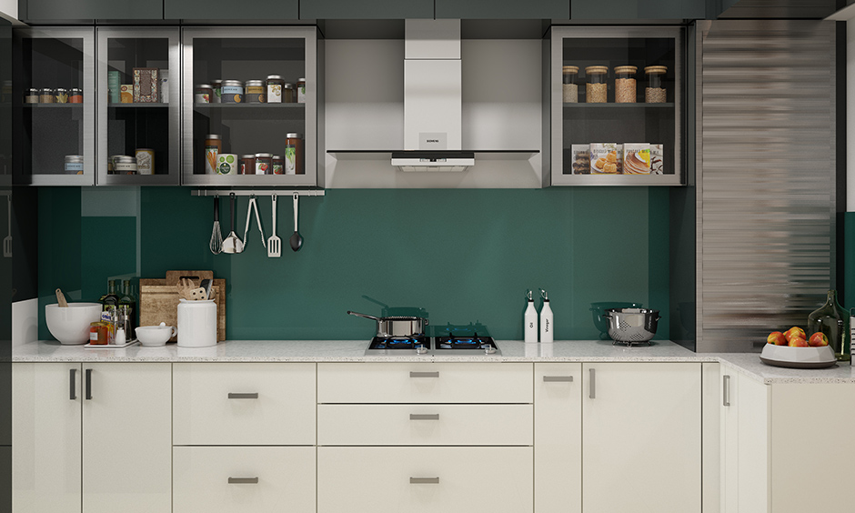 Plain green backsplash with grey cabinet and white wardrobe design in kitchen gives space a modern look