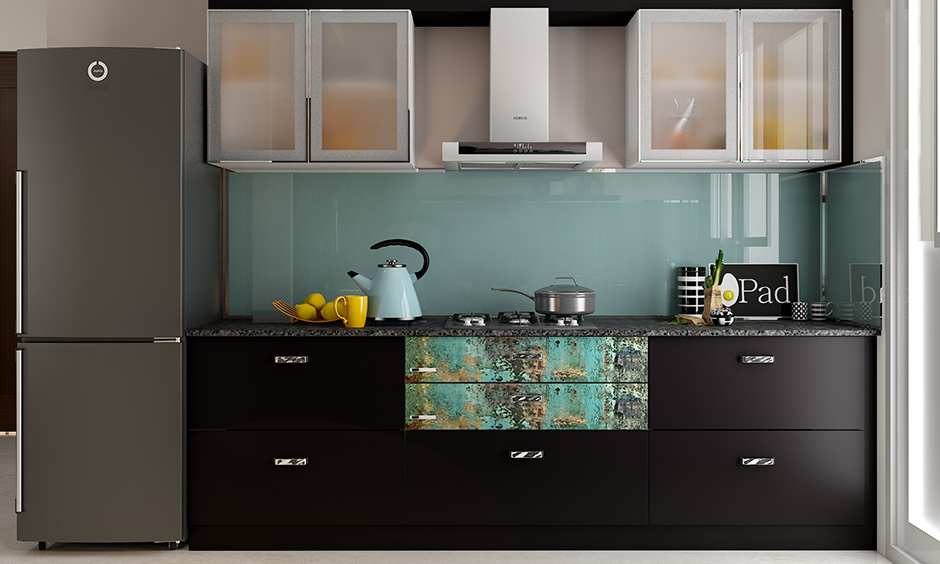 Compact modular kitchen and wardrobe designs with black laminate take care of form and functionality in small space.