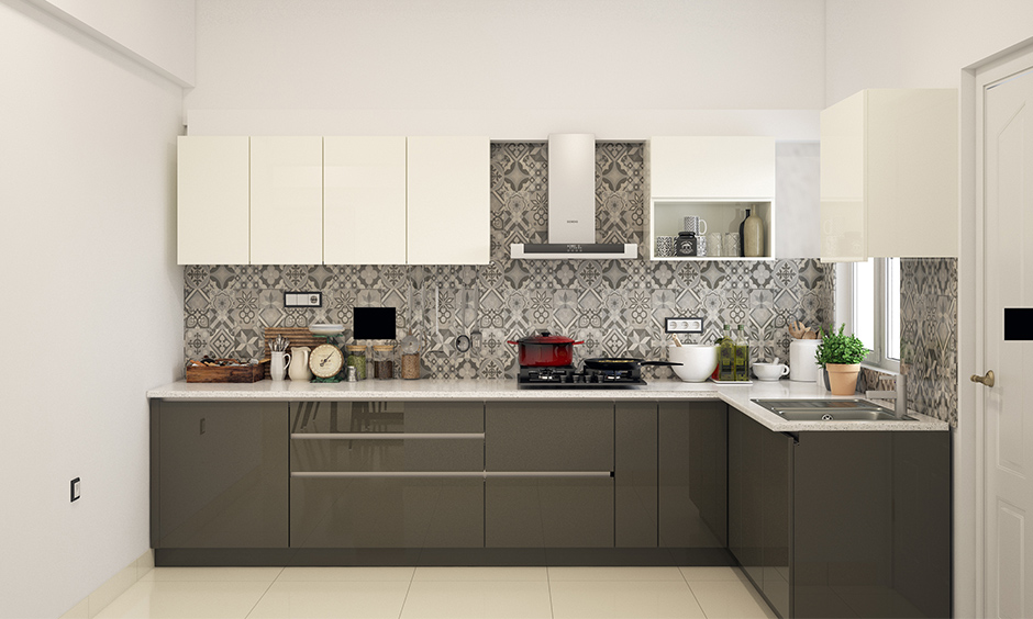 Modular kitchen wardrobe designs in grey look alluring with patterned backsplash and the touch of white.