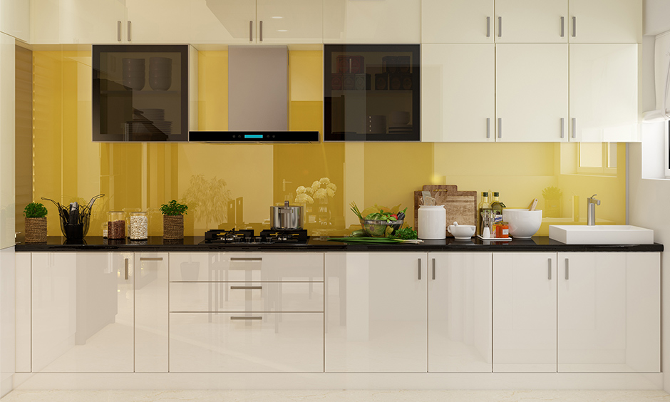 Background sunny yellow modular kitchen and wardrobes with white laminate brighten things up.
