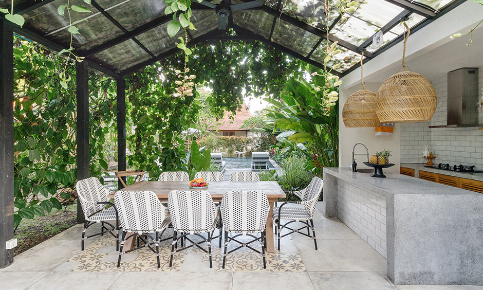 Outdoor pavilion kitchen with a glass patio and a hint of nature makes outdoor kitchen