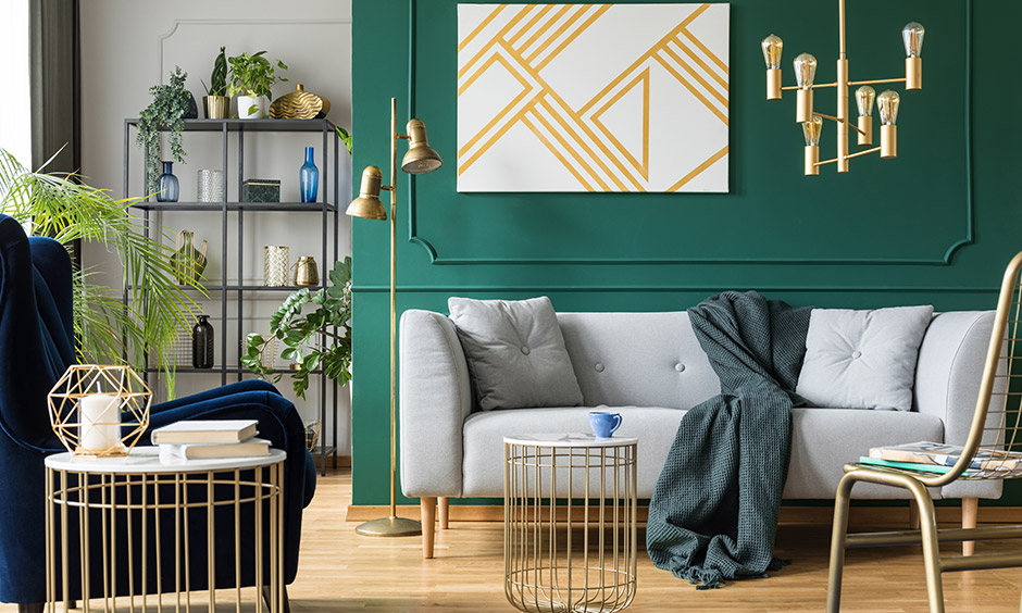 Dark accent wall in living room with beautiful wall mouldings adds to the sophistication of the space