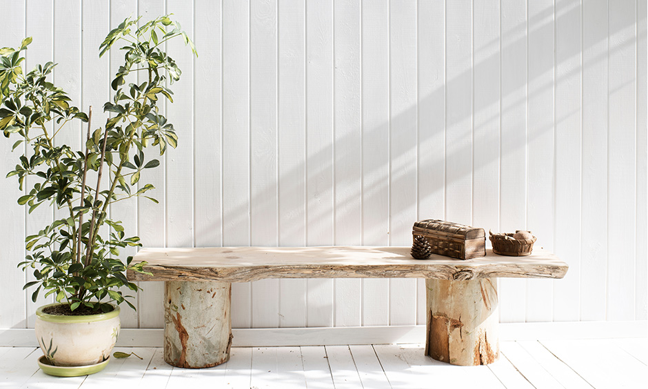 Patio seating made from reclaimed wooden logs outdoor is a modern farmhouse architecture DIY.