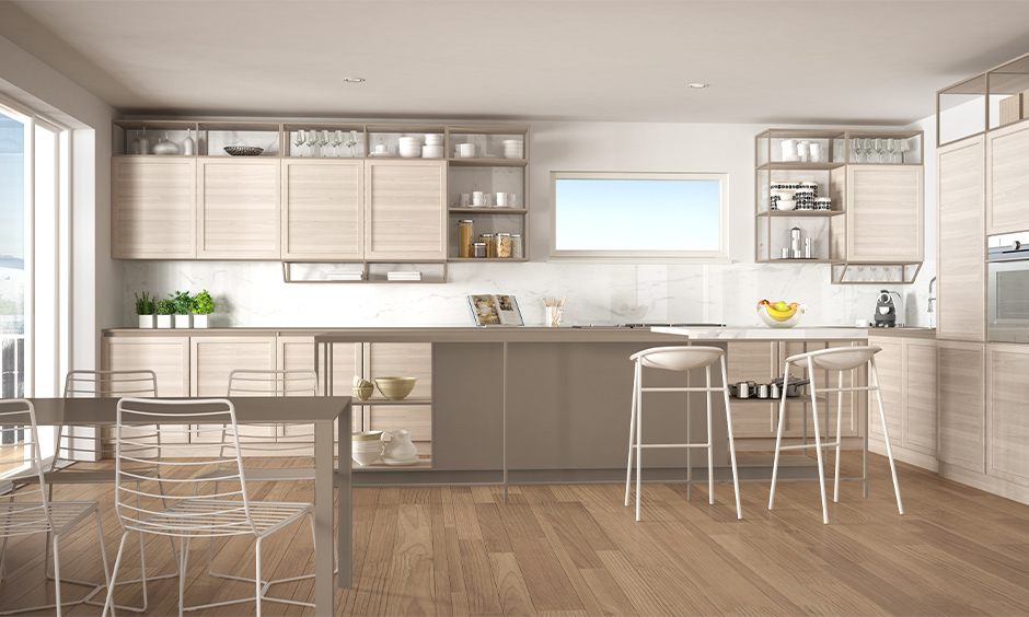 This kitchen cum dining area has timber-framed open shelving units in the kitchen with light wooden flooring.