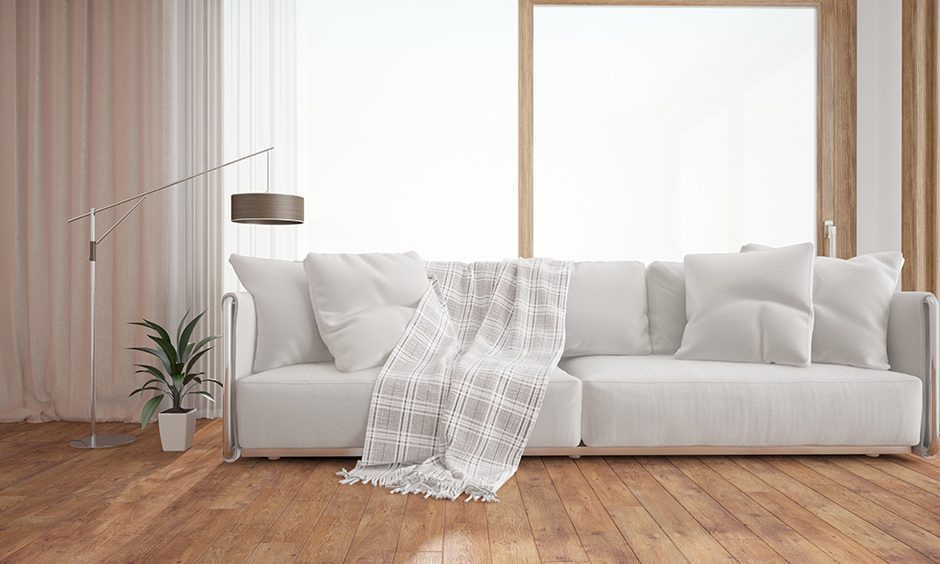 Low-height modern white sofa on wooden floor in a living room