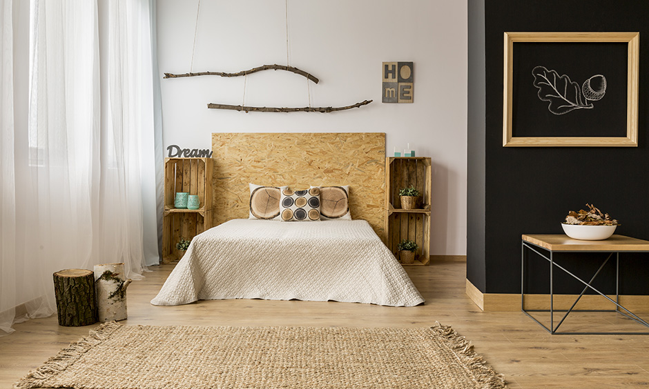 Modern Farmhouse Bedroom design with dried tree branch, wooden headboard, rug & potpourri is modern farmhouse interior design style.