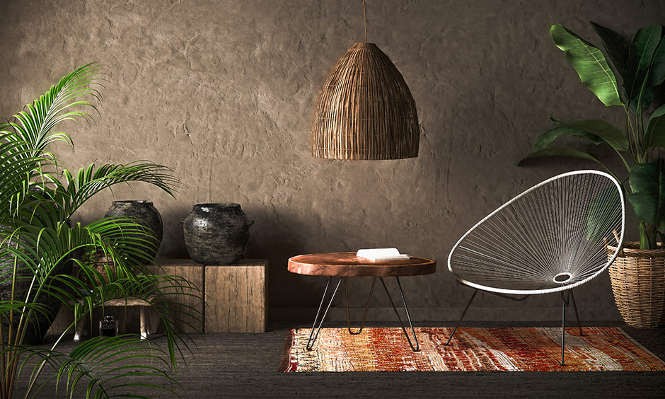 Beautiful modern farmhouses earth-toned textured wall, wicker chair, coffee table & plants are the stunning reading nook.
