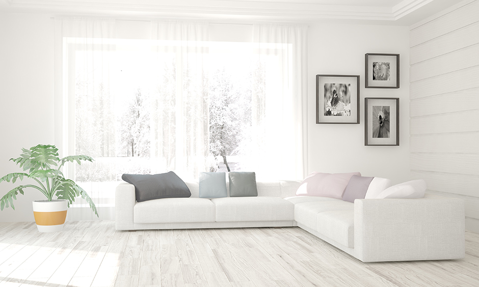 An white l-shaped sofa in an all-white living room - perfect for minimalist interior design