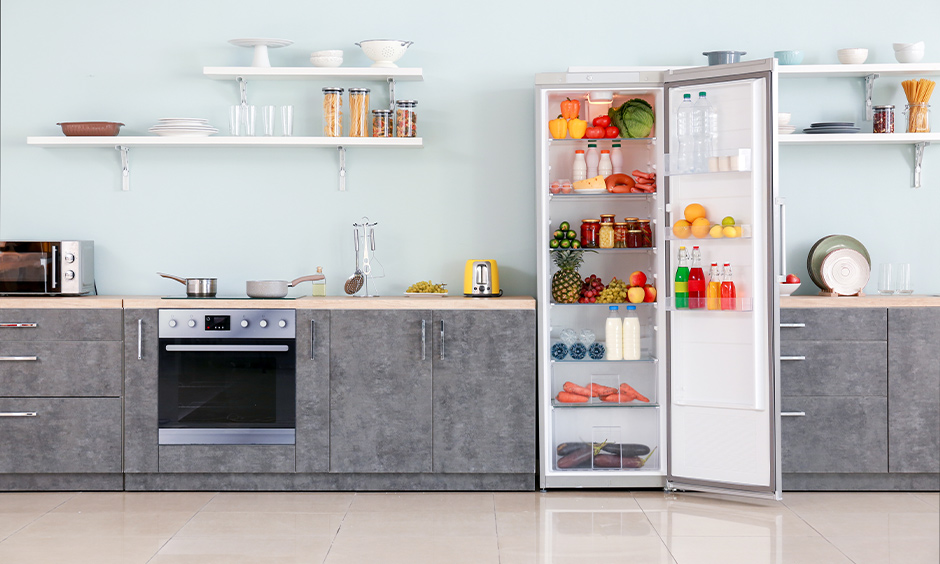 Kitchen has simple open kitchen shelves above a white granite countertop for easy and hassle-free storage.