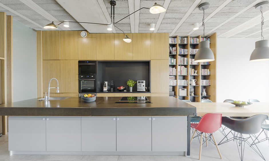 An island kitchen with vertical open shelving kitchen ideas for pots and books storage looks rustic.