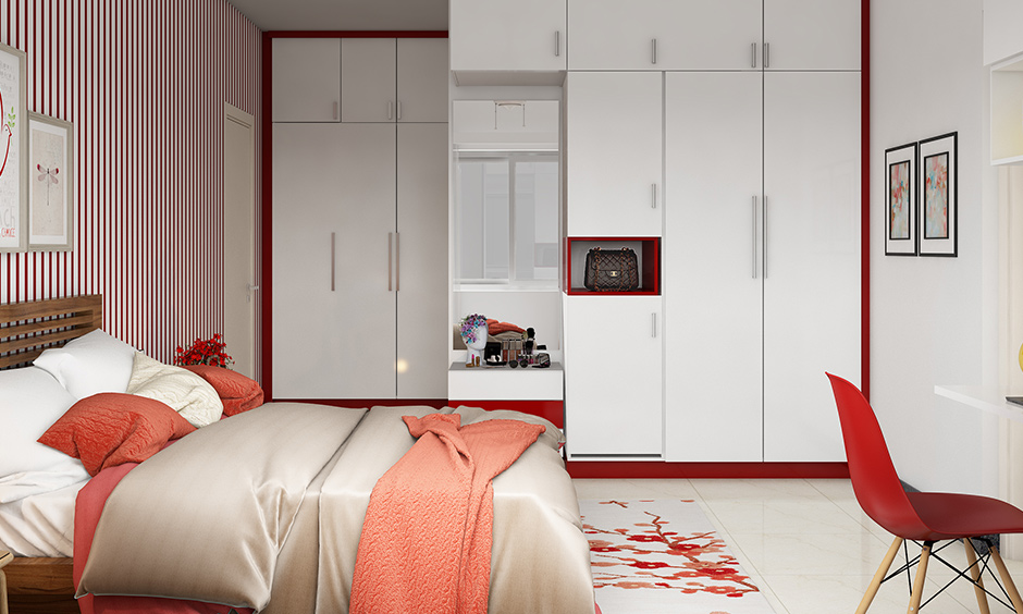 Bedroom wardrobe colour combinations in white & red on the border with a dressing table is a sleek design