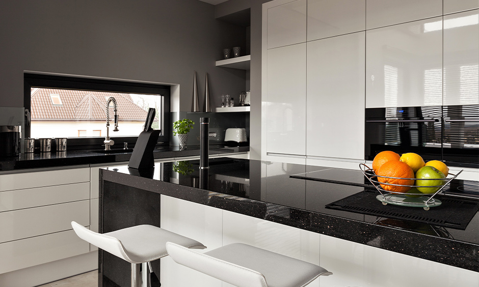 Galaxy black granite countertops with white cabinets in grey kitchen island create an overall eye-catching kitchen design.