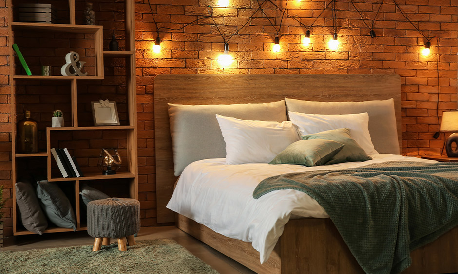 Brick wall with hanging fairytale lights in the bedroom and comes with bookshelves brings the rustic vibe.