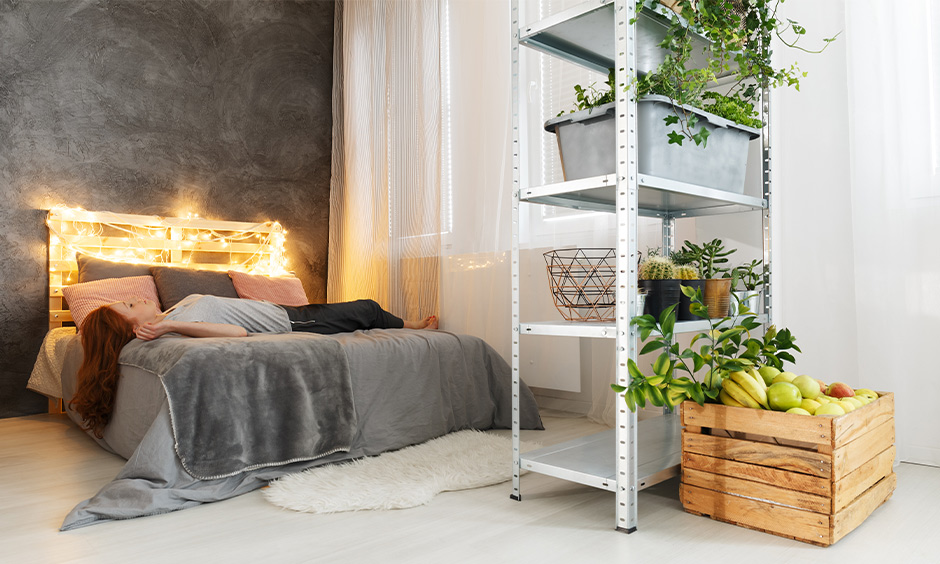 Grey and white bedroom comes with a queen-size bed and wooden headboard with fairy lights bedroom decor.