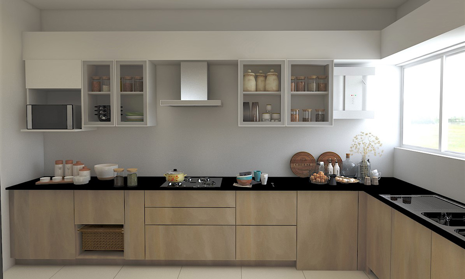 Jet black granite countertops along with the brown cabinets bring in a contemporary vibe to the l-shaped kitchen.