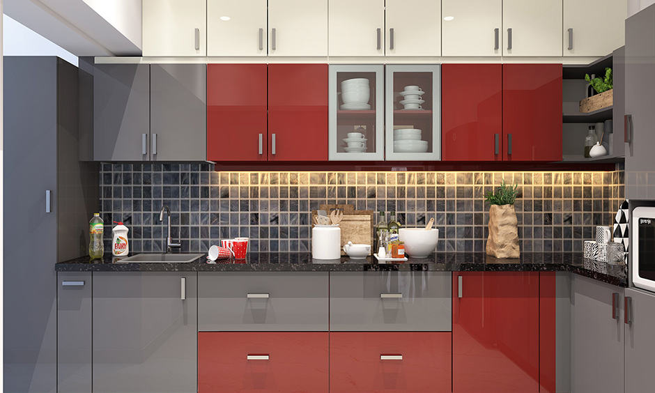Kitchen cabinets have a red and grey laminate shutter finish that is durable and smooth.