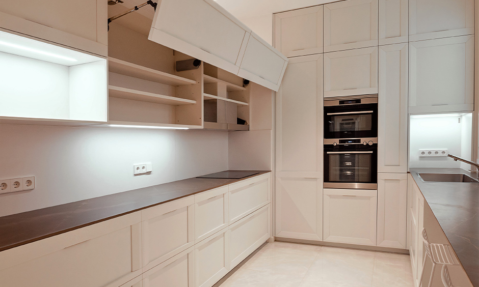 This parallel white kitchen has a lift-up kitchen shutter door for space-saving and cleaning it is easy-peasy.