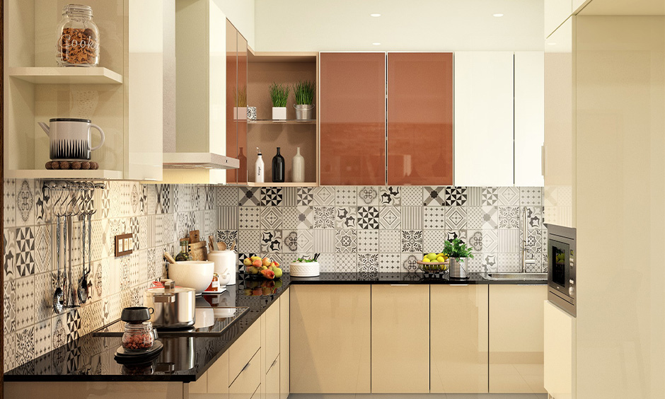 Polished black granite countertops and cream coloured cabinets lend a strong and bold character to the kitchen.