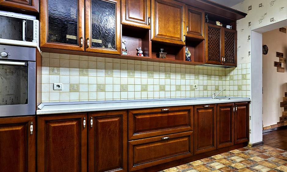 PU coated kitchen shutters in the brown finish gives a seamless and sleek look to the kitchen space.