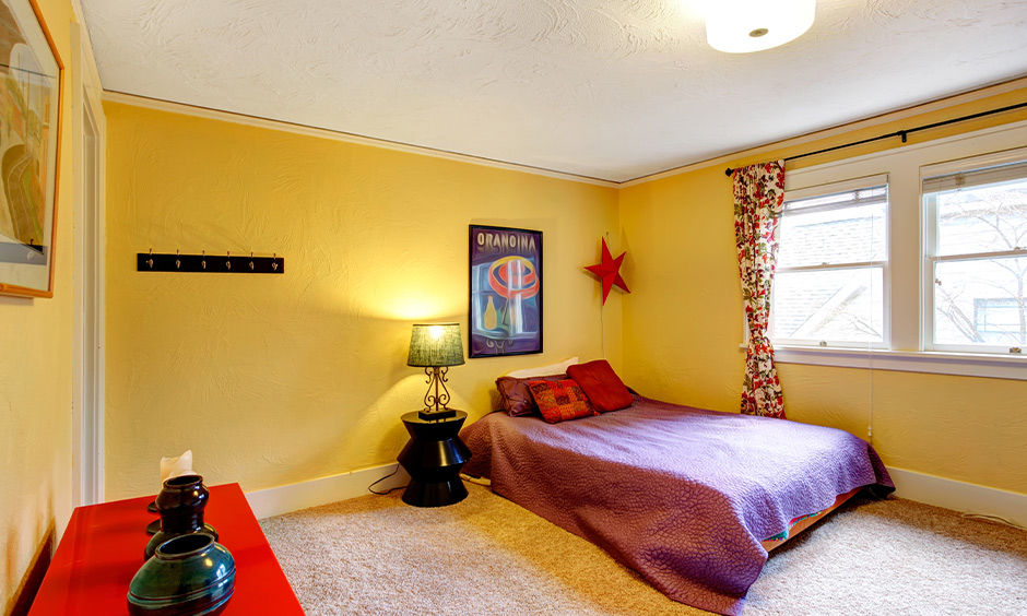 Bold red or printed curtains for yellow walls in your living room to add warmth