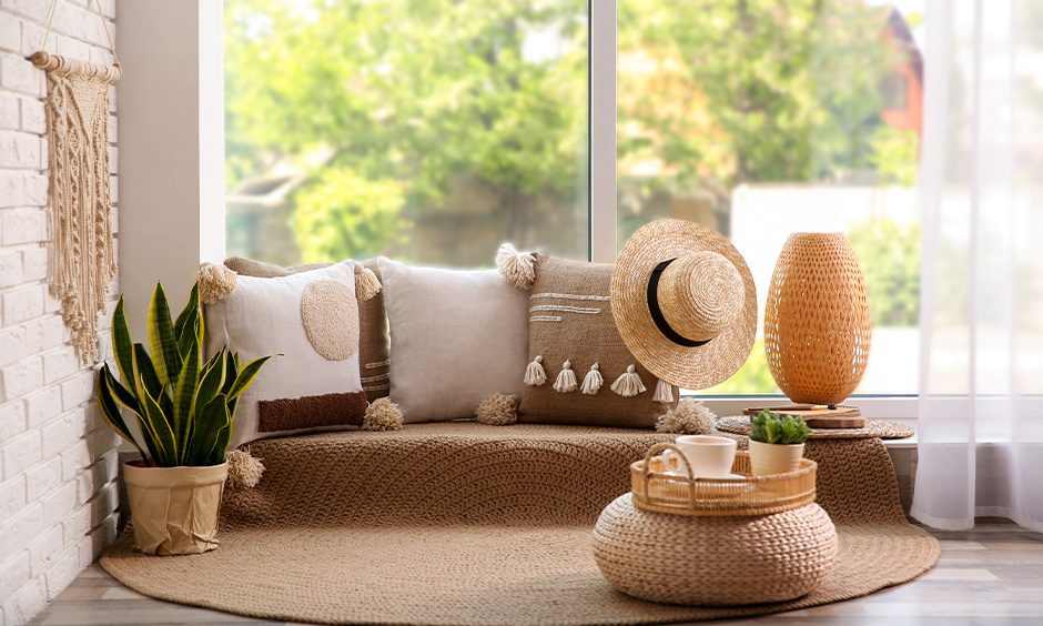 Floor seating idea for the bedroom, straw cushions and a rug arranged near the window creates a harmonious look.