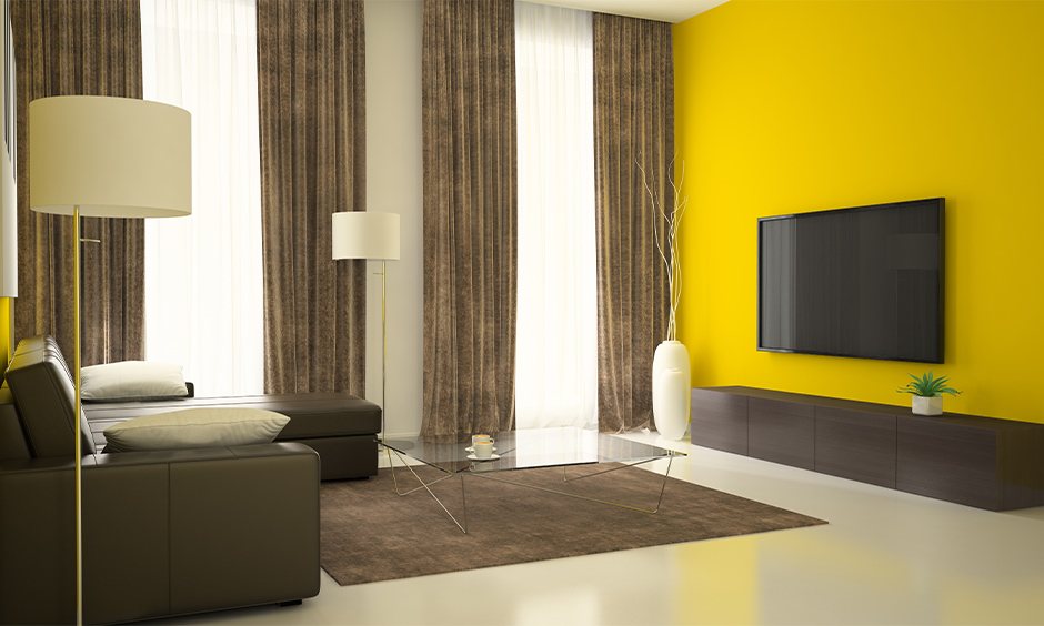 Grey and beige curtain for yellow walls which gives the feel of five-star hotel