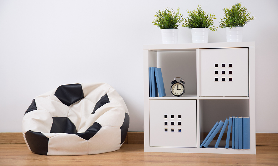 Floor seating idea, a soccer-themed bean bag in the living room next to the bookshelf evaluates the look.