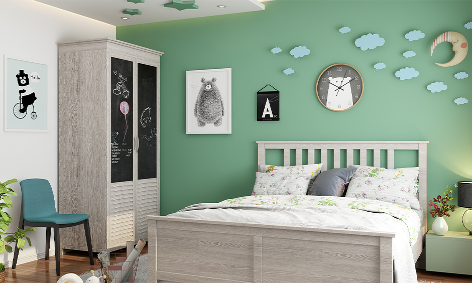 Kid's bedroom vintage wardrobe decorated with paint and attached blackboard look chic old almirah decoration.