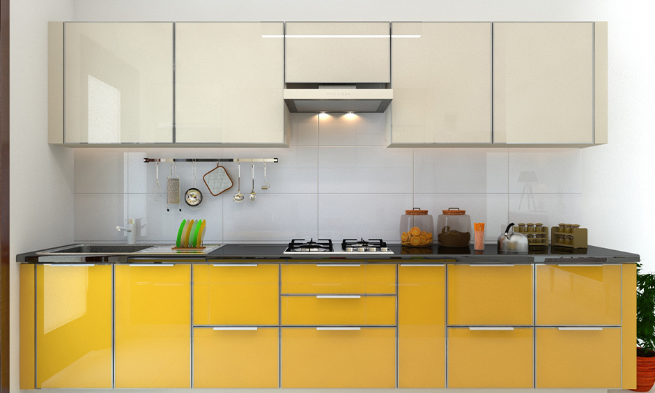 One-wall kitchen has gloss finish kitchen cabinets in white and yellow colour look plusher.