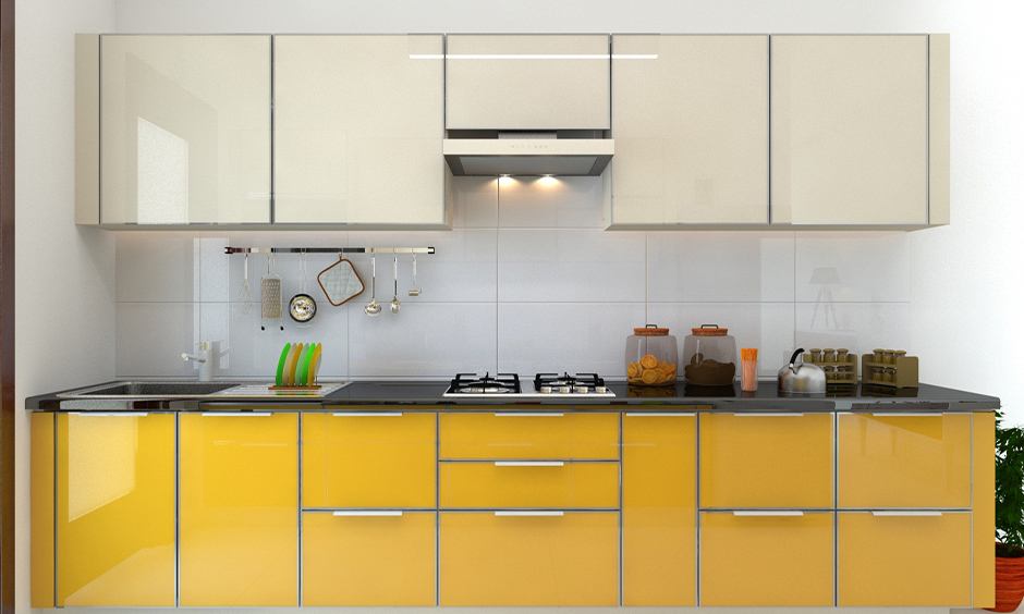 One-wall kitchen has gloss finish kitchen cabinets in white and yellow colour look plusher.