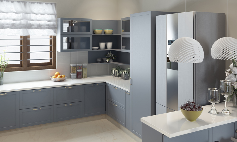 Small kitchen designed with matt finish cabinets in grey colour looks modern is the best finish for kitchen cabinets.