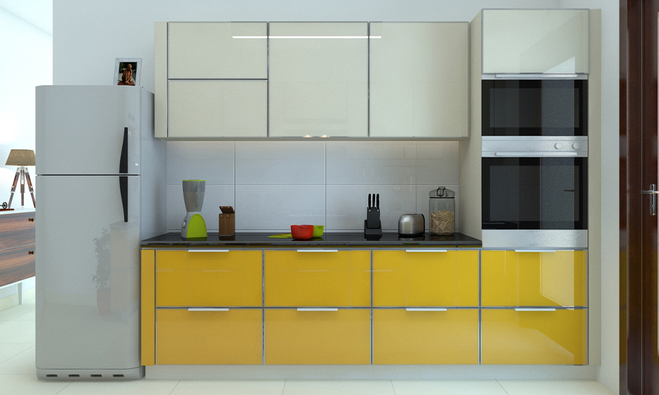 White and yellow modular kitchen with high gloss finish cabinets look luxurious and soothing.