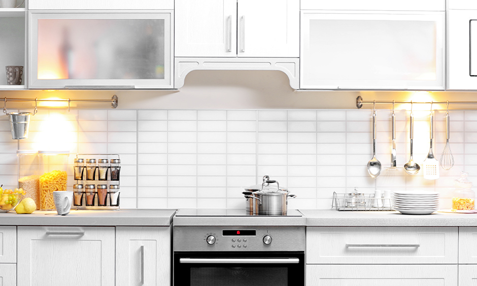 All-white kitchen under cabinet lighting with bright lamps is simple yet classic.