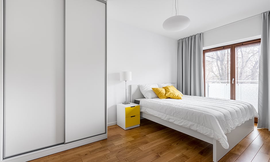 Floor-to-ceiling bedroom cupboard in minimal grey and white design