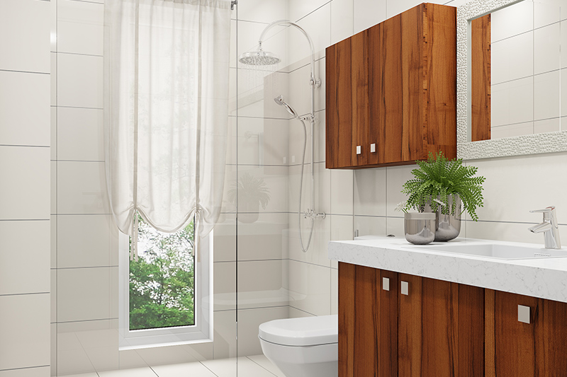 Bathroom renovation with white porcelain tiles, a thick-glass divider and wooden cabinets looks sleek.
