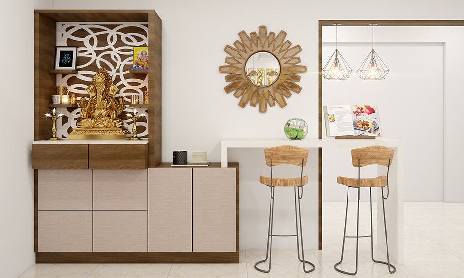 Compact pooja room placed at the corner with minimal design is the cupboard design for the pooja room.