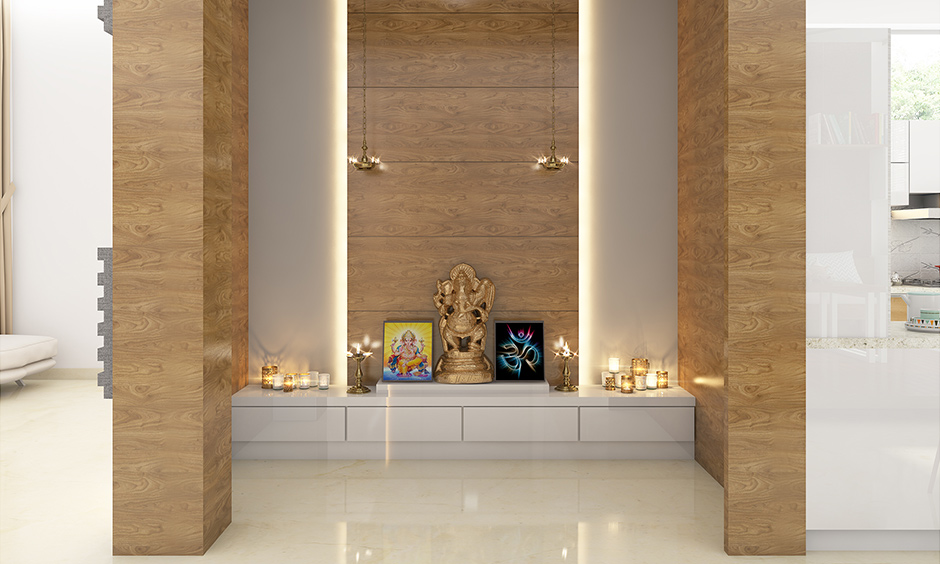 Pooja room cupboard designed in a modern look with white lamination brings an elegant look.