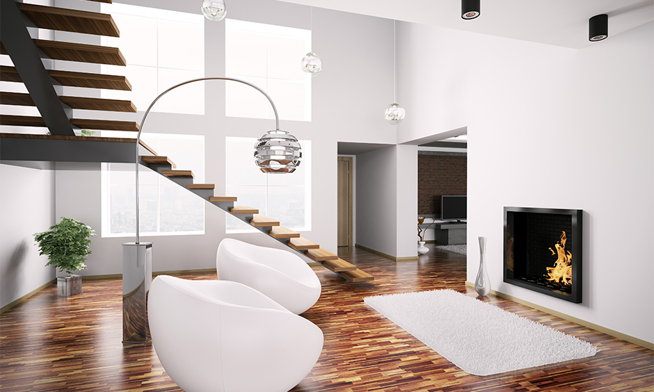 A contemporary modern staircase made from wood in minimalistic and pendant lights complete the look of space