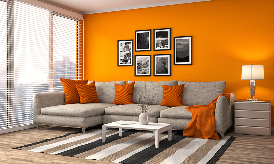 modern living home decorated with a sectional sofa and an orange accent wall