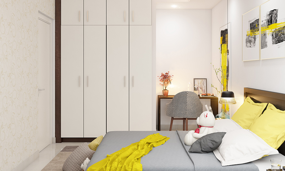 A space-saving wardrobe that blends in with the walls and has loft storages