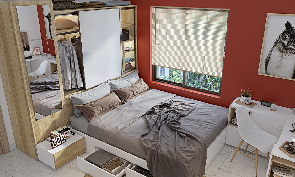 A space saving wardrobe design that has a wardrobe on the bed's headboard