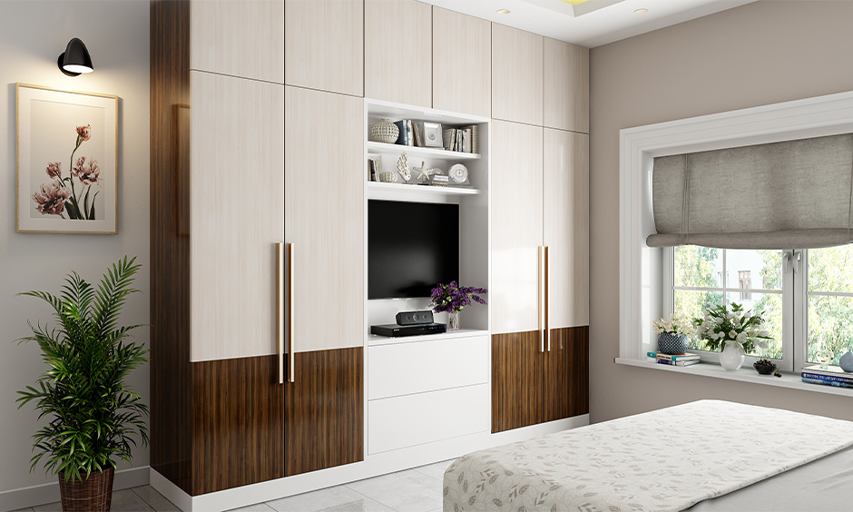 Space-saving wardrobe design that has floor-to-ceiling wardrobe with a TV unit