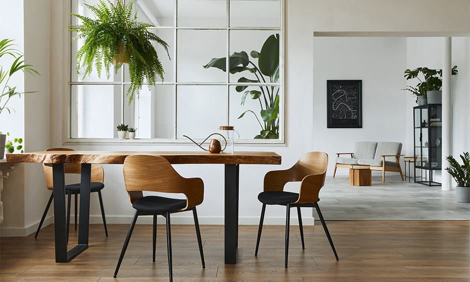 An industrial dining table designed with the shape of the log kept intact