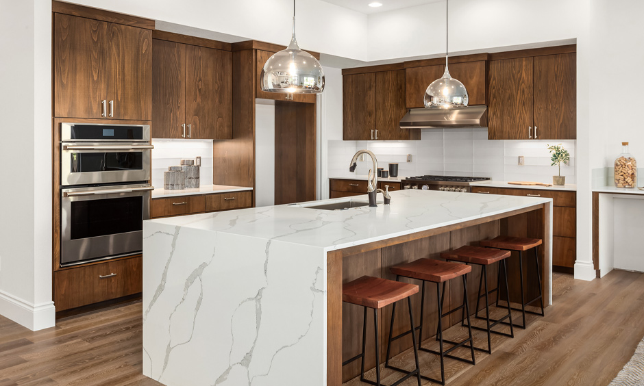 Modern galley kitchen with island marble top and seating lends a luxury look