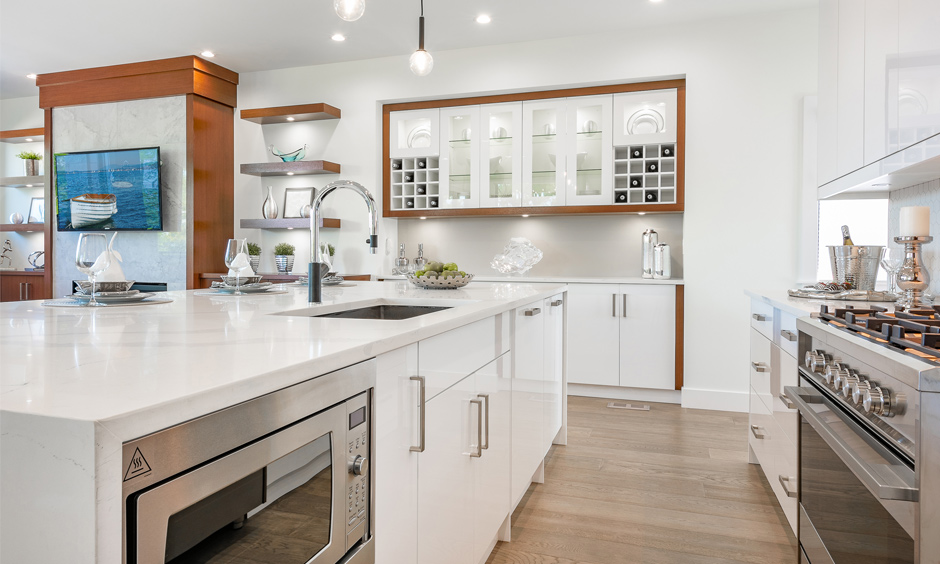 A modern kitchen island with a hood and oven is a space-saving design and makes work easy