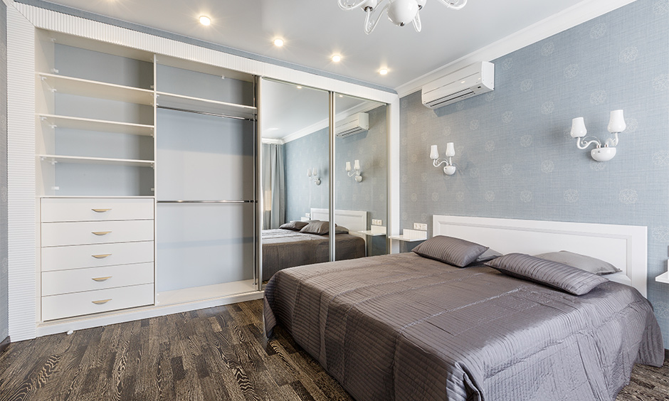Plywood wardrobe door design with mirror helps reflect light in the bedroom optimally
