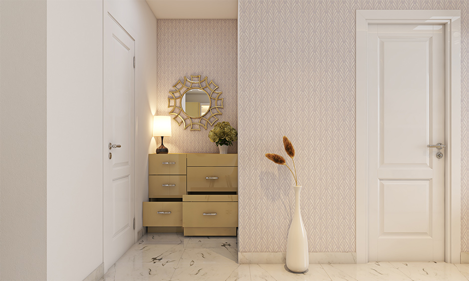 An entryway design guide with a side cabinet with multiple pull-out units helps keep your space clutter-free