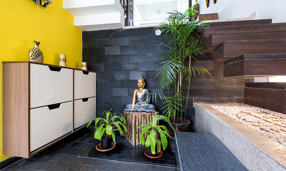 A floating entryway table is positioned against a wall and features a built-in shoe rack
